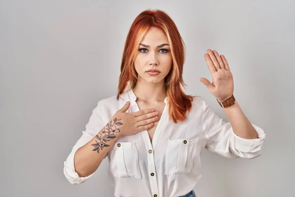 Young Caucasian Woman Standing Isolated Background Swearing Hand Chest Open — стоковое фото