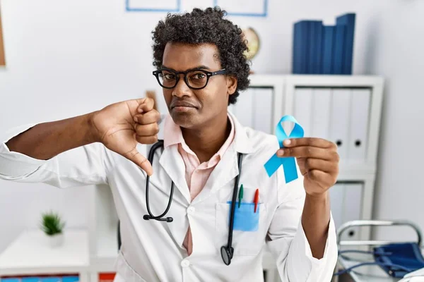 African Doctor Man Holding Blue Ribbon Angry Face Negative Sign — 图库照片
