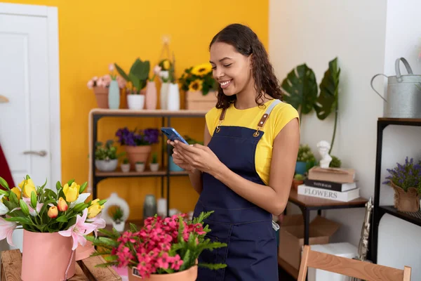 Young African American Woman Florist Smiling Confident Using Smartphone Flower —  Fotos de Stock