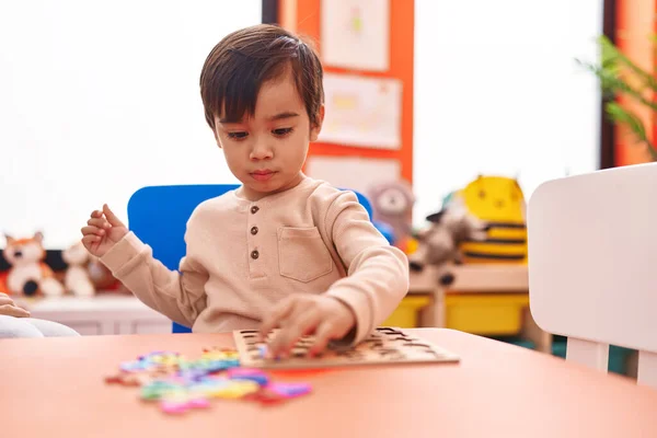 Adorable Hispanic Boy Playing Maths Puzzle Game Sitting Table Kindergarten — Stock fotografie