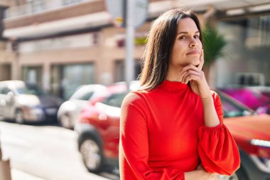 Sokakta şüpheli bir ifadeyle duran genç, güzel İspanyol kadın.