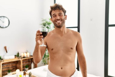 Genç İspanyol, kendine güvenen, güzellik merkezinde şarap içen adam.