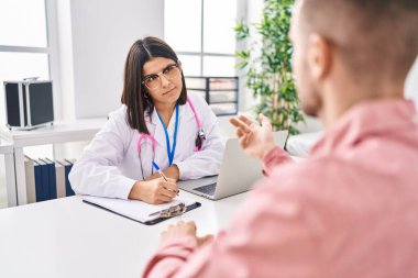 Man and woman doctor and patient having medical consultation at clinic