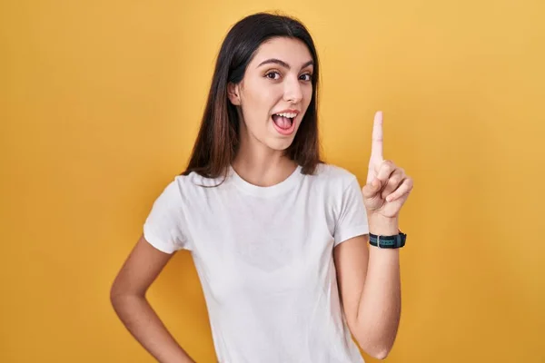 Young Beautiful Woman Standing Yellow Background Pointing Finger Successful Idea — Foto de Stock