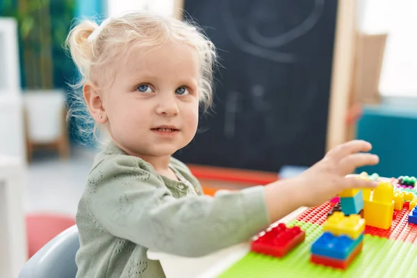 Adorable Blonde Girl Playing Construction Blocks Sitting Table Kindergarten — 스톡 사진