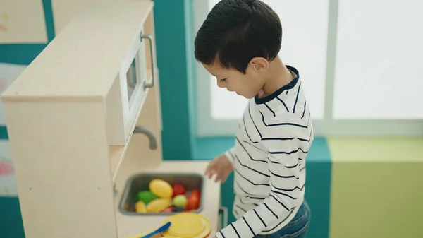 Adorable Hispanic Boy Playing Play Kitchen Standing Kindergarten — ストック写真