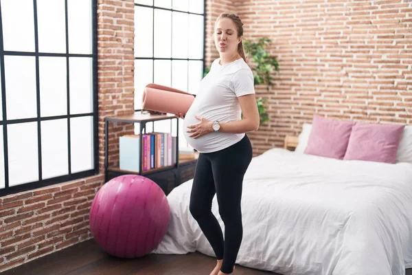 Young Pregnant Woman Holding Pilate Mat Bedroom Puffing Cheeks Funny — Stock Photo, Image