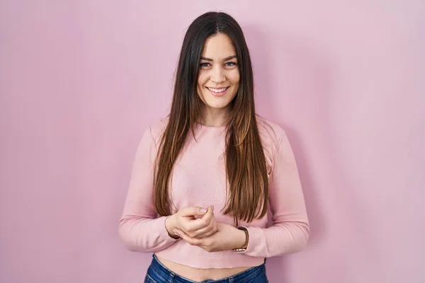 Young Brunette Woman Standing Pink Background Hands Together Crossed Fingers — 图库照片