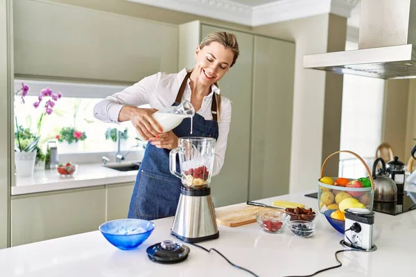 Young Blonde Woman Smiling Confident Pouring Milk Blender Kitchen — Stock Photo, Image
