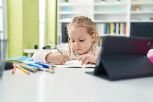 Adorable Blonde Girl Student Using Touchpad Writing Notebook Classroom — Stok fotoğraf