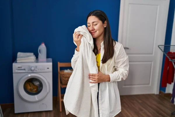 Young Hispanic Woman Touching Face Soft Towel Laundry Room — Foto de Stock