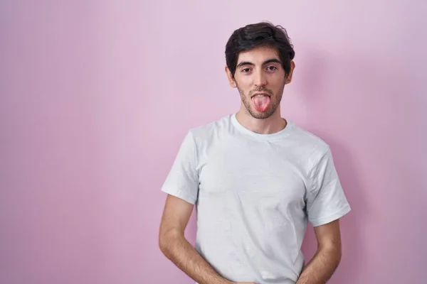 Young Hispanic Man Standing Pink Background Sticking Tongue Out Happy —  Fotos de Stock