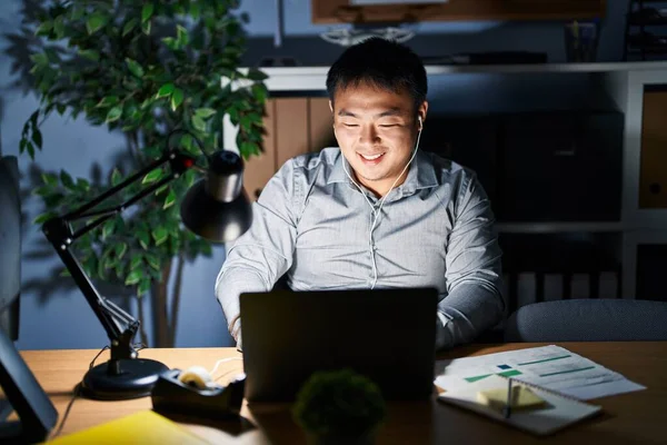 Young Chinese Man Working Using Computer Laptop Night Winking Looking — Stockfoto
