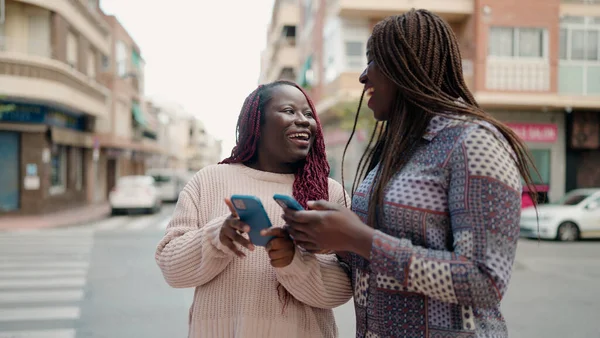 Two African American Friends Smiling Confident Using Smartphone Street — Stok fotoğraf