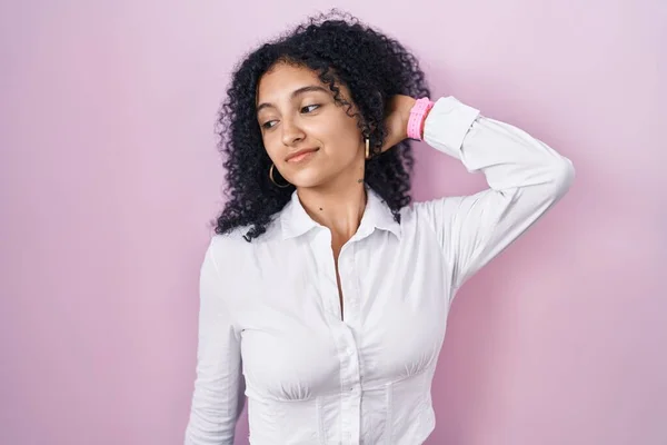 Hispanic Woman Curly Hair Standing Pink Background Stretching Back Tired — Stockfoto