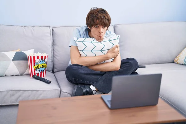 Hispanic Young Man Watching Horror Movie Laptop Making Fish Face — Foto de Stock