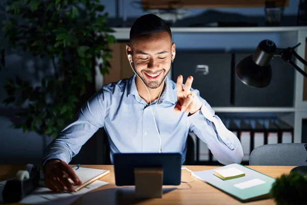Young Hispanic Man Working Office Night Smiling Happy Face Winking — Stok fotoğraf