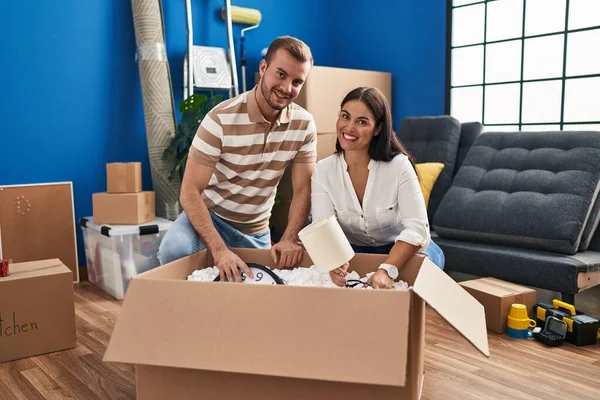 Man Woman Couple Smiling Confident Unboxing Package New Home — Fotografia de Stock