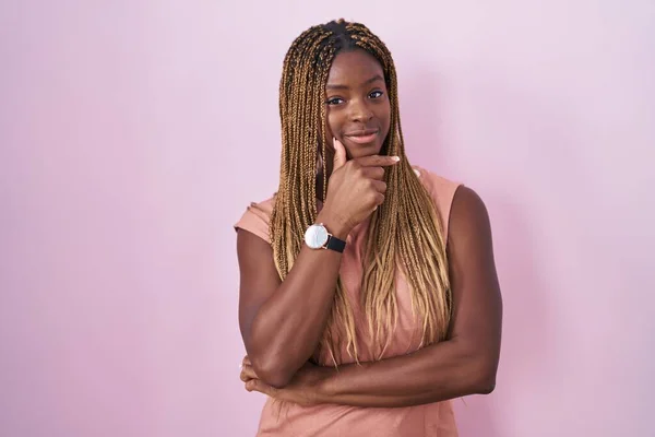 African American Woman Braided Hair Standing Pink Background Looking Confident — Zdjęcie stockowe