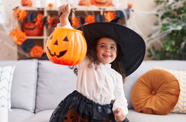 Adorable Hispanic Girl Wearing Halloween Costume Holding Pumpkin Basket Home — Fotografia de Stock