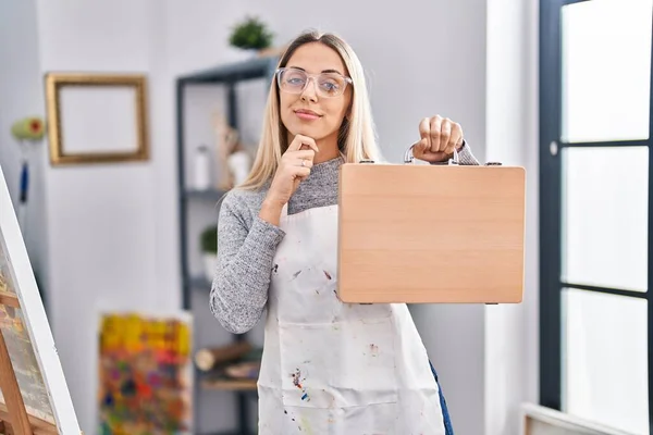 Young Blonde Painter Woman Holding Wooden Case Art Studio Serious — Foto de Stock