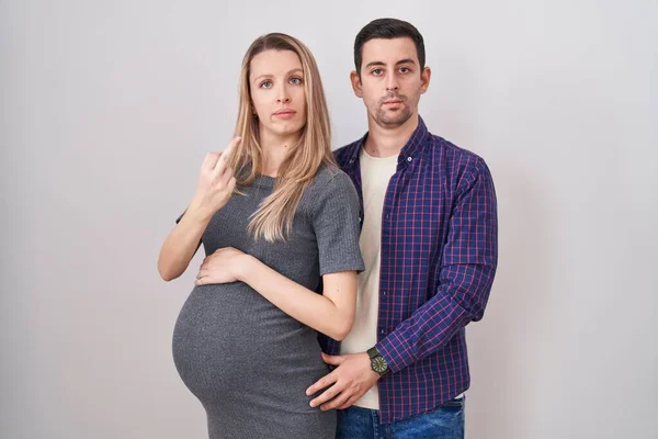 Young Couple Expecting Baby Standing White Background Showing Middle Finger — Stock Photo, Image