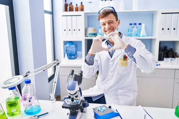 Biały Mężczyzna Pracujący Laboratorium Naukowym Uśmiechający Się Zakochany Robiący Dłońmi — Zdjęcie stockowe
