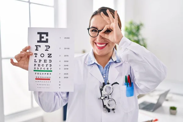Young Hispanic Optician Woman Holding Medical Exam Smiling Happy Doing — Fotografia de Stock