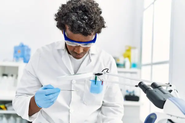 Young South East Man Wearing Scientist Uniform Looking Sample Using — Stock Photo, Image