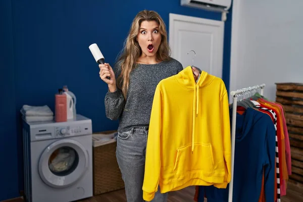 Young Woman Using Lint Roll Remover Hair Clothes Afraid Shocked — Stok fotoğraf