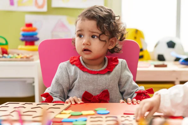 Adorable Hispanic Toddler Playing Maths Puzzle Game Sitting Table Kindergarten — Stock fotografie