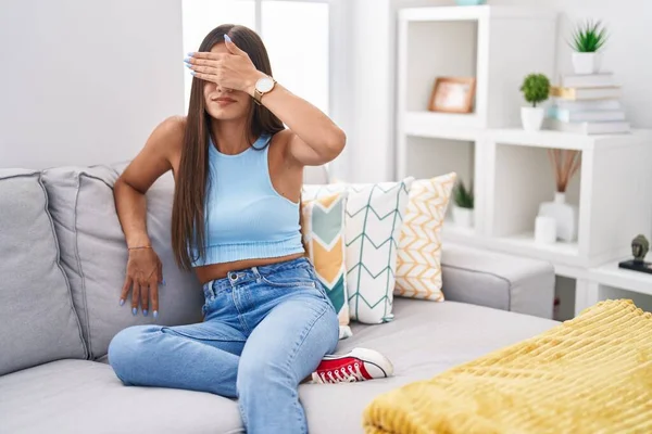Young Brunette Woman Sitting Sofa Home Covering Eyes Hand Looking — Stock Photo, Image