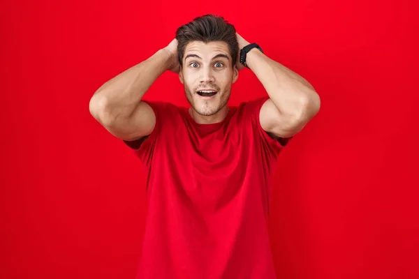 Young Hispanic Man Standing Red Background Crazy Scared Hands Head — Stockfoto