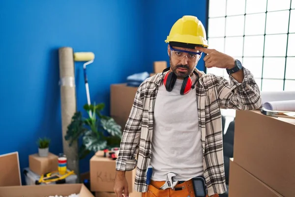 Young Hispanic Man Beard Working Home Renovation Pointing Unhappy Pimple — Stockfoto