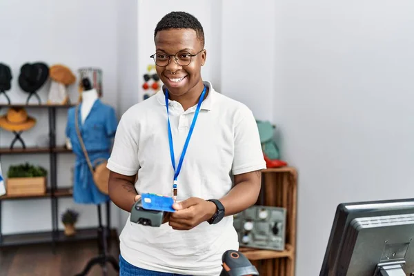 Young african man working as shop assistance doing purchase at retail shop