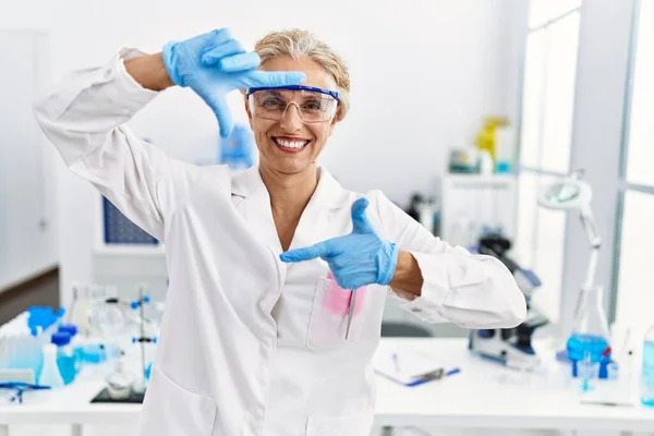 Middle Age Blonde Woman Working Scientist Laboratory Smiling Making Frame — 스톡 사진