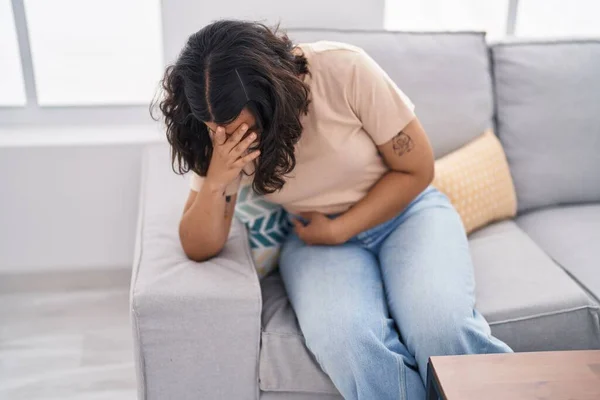 Young Woman Suffering Menstrual Pain Sitting Sofa Home — Stockfoto