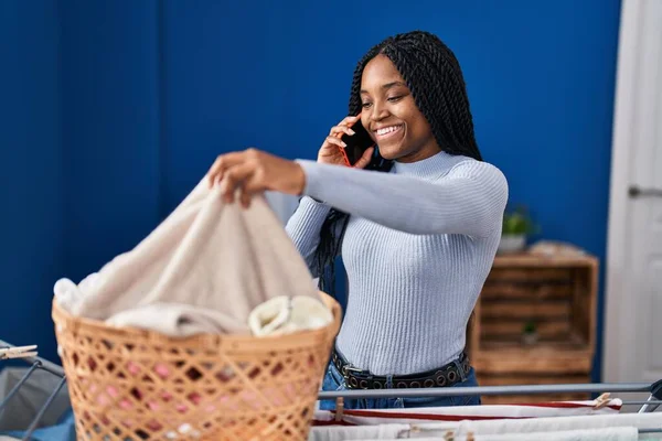 African American Woman Talking Smartphone Hanging Clothes Clothesline Laundry Room — Stockfoto