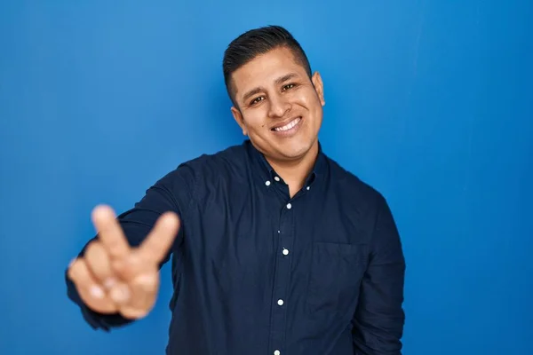Hispanic Young Man Standing Blue Background Smiling Looking Camera Showing — Stock fotografie