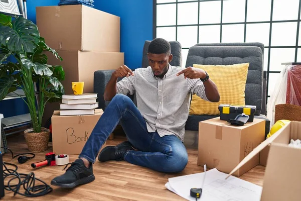 African American Man Sitting Floor New Home Pointing Fingers Showing — Stock Photo, Image