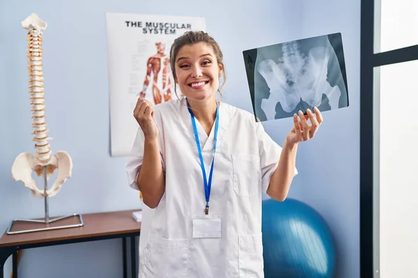 Young Woman Holding Pelvis Radiography Screaming Proud Celebrating Victory Success — Stock Photo, Image