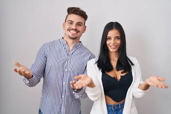 Young Hispanic Couple Standing White Background Smiling Cheerful Offering Hands — Stock Photo, Image