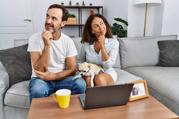 Hispanic Middle Age Couple Sitting Sofa Using Computer Laptop Serious — Φωτογραφία Αρχείου