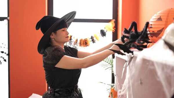 Young Chinese Woman Wearing Witch Costume Decorating Halloween Party Home — Fotografia de Stock