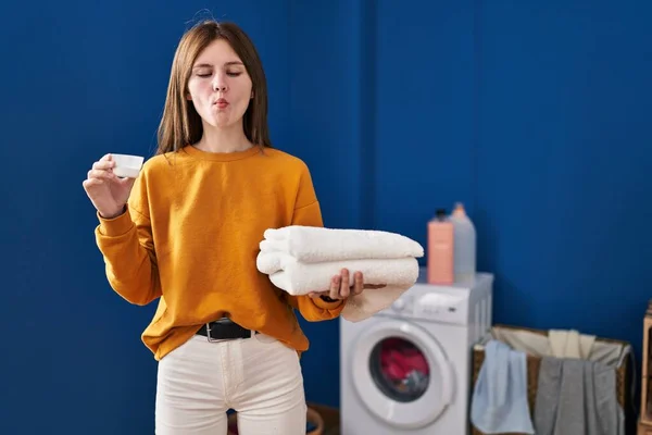 Young Brunette Woman Holding Detergent Clean Laundry Making Fish Face — Stockfoto