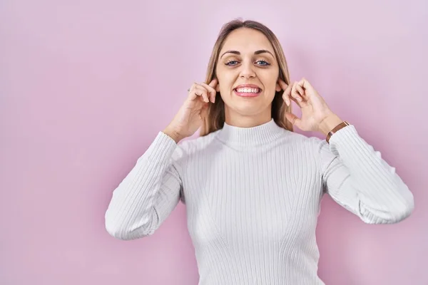 Young Blonde Woman Wearing White Sweater Pink Background Covering Ears — Foto Stock