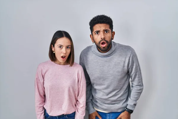 Young Hispanic Couple Standing Together Afraid Shocked Surprise Amazed Expression — Stockfoto