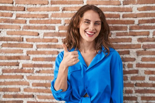 Beautiful Brunette Woman Standing Bricks Wall Doing Happy Thumbs Gesture — Stock fotografie