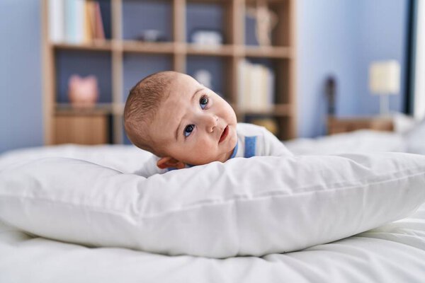 Adorable baby relaxed lying on bed at bedroom