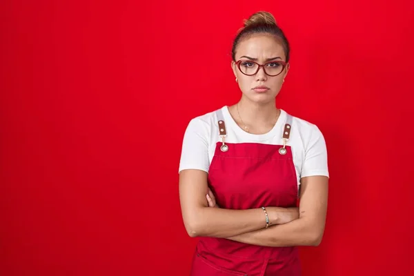 Młoda Latynoska Kobieta Fartuchu Kelnerki Czerwonym Tle Sceptyczna Nerwowa Dezaprobata — Zdjęcie stockowe
